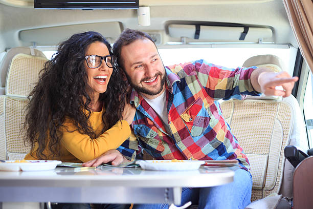 istock Happy couple having fun inside of caravan 530581990
