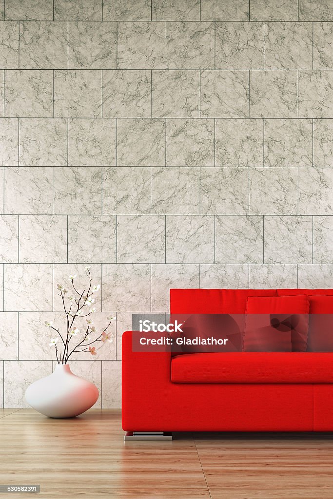 Red sofa - Stock Image Decorated interior with red sofa on hardwood floor and tiled marble wall in background. Gray Color Stock Photo