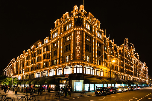 London, United Kingdom - September  25, 2014: The famous Harrods department store in the evening of September 25, 2014 at Knightsbridge in London, UK. Harrods is the biggest department store in Europe and offers over one million square feet of retail space, acting as a magnet for rich clients and numerous tourists throughout the year.