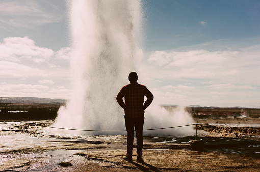 Man standing near the geyser