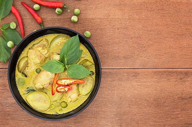 istock Thai chicken green curry with old wooden background 530583778
