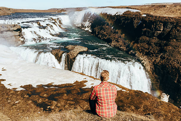 istock Man near the waterfall 530583998