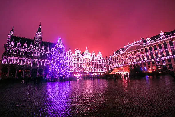 People are visiting  famous cityhall at night during christmas of brussel belgium