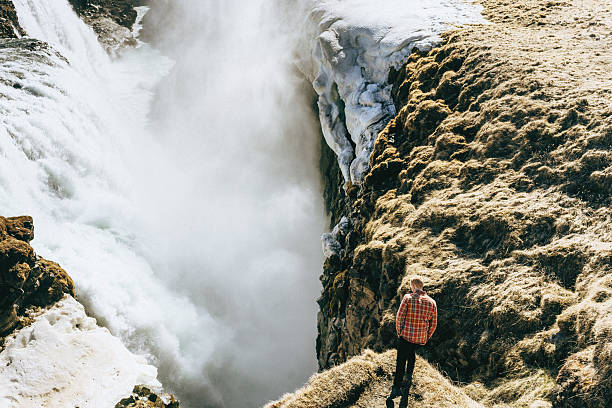 istock Man near the waterfall 530584066
