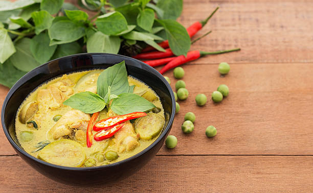 istock Thai chicken green curry with old wooden background 530584222