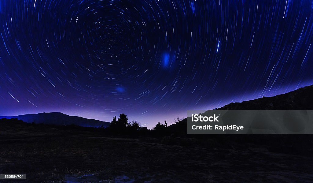Star trails around the celestial South Pole Stars whirling around the celestial south pole. The Large and Small Magellanic Clouds can be seen below and to the right of the pole. Shot in the Cederberg Mountains, north of Cape Town in a wide-angle, long exposure shot. Africa Stock Photo