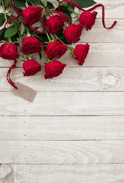 istock Valentine's day red roses bouquet on old rustic wood table 530584967