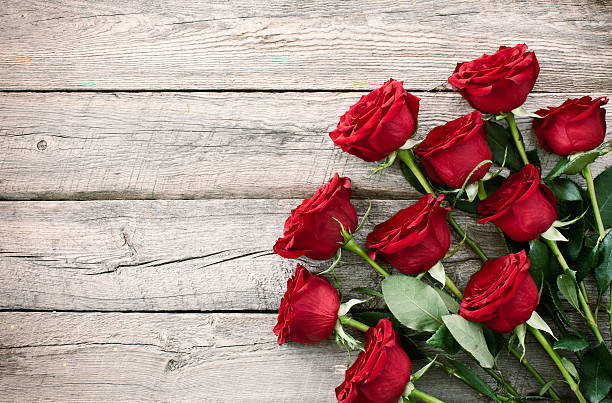 Valentine's day red roses bouquet on old rustic wood table