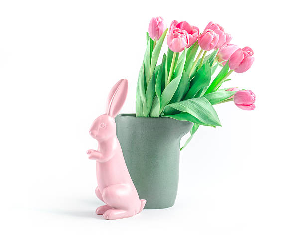 Pastel-coloured pink easterbunny with tulips stock photo