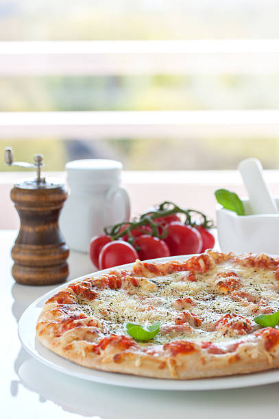 istock Fresh baked pizza with melted cheese, Italian herbs and tomatoes 530585376