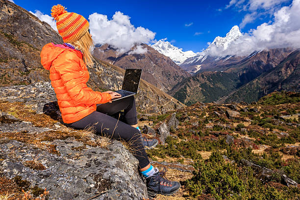 istock Young woman using laptop in Himalayas, Nepal 530586330