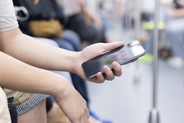 istock businessman using smart phone in subway train 530586577
