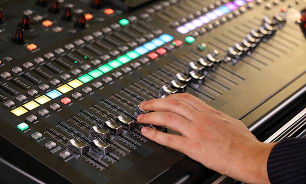istock hand and potentiometers and sound equalizer  during a rock conce 530587036