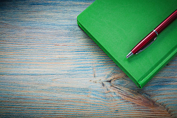 istock Notepad pen on wooden board office concept 530587262