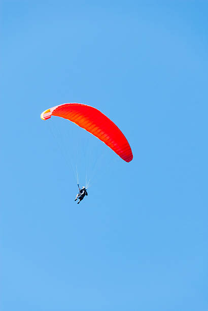 istock Hang Glider floats across a Blue Sky 530587544