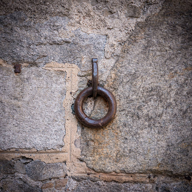 istock Old sandstone wall with a single metal ring 530589368