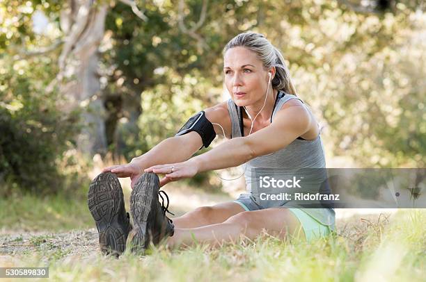 Senior Woman Stretching Stock Photo - Download Image Now - Mature Women, Exercising, Women