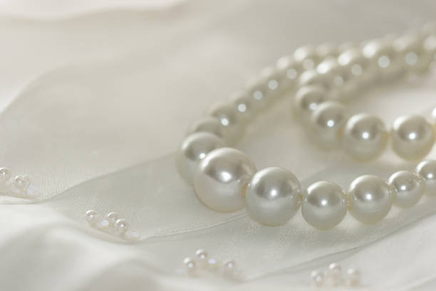 istock Pearl necklace on lace background,selected focus. 530591995