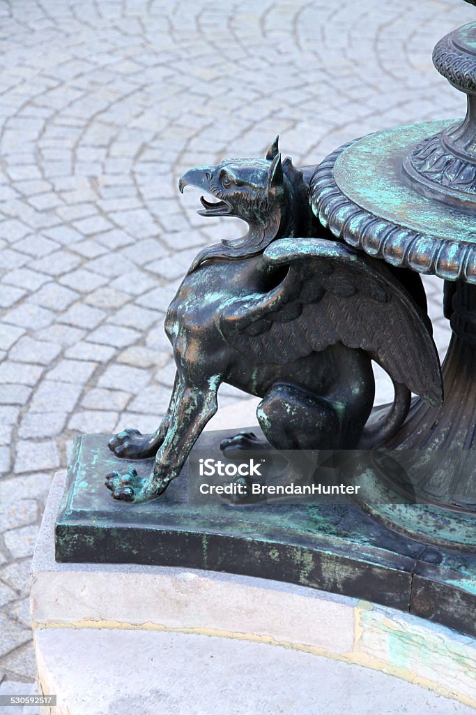 Griffin Post An iron griffin in the plaza of the Austrian Parliment.  Ancient Stock Photo