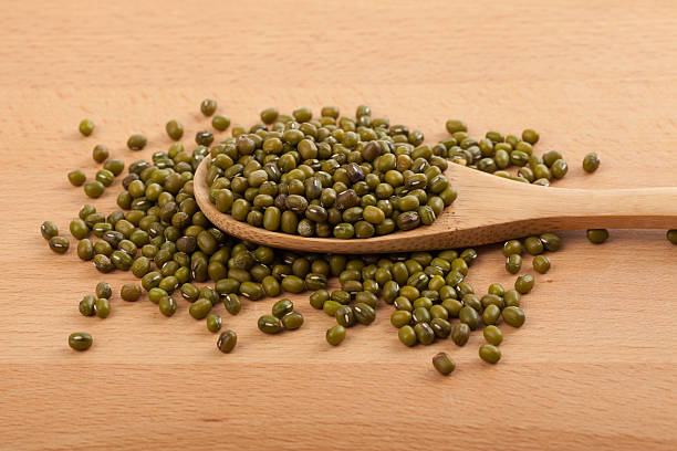 istock Mung beans with wooden spoon 530592893