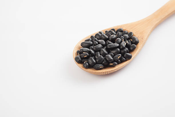 istock Black beans with wooden spoon 530601199
