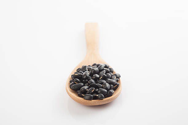 istock Black beans with wooden spoon 530601207