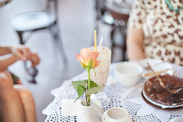 istock Fresh rose in white vase on table in cafe 530601857