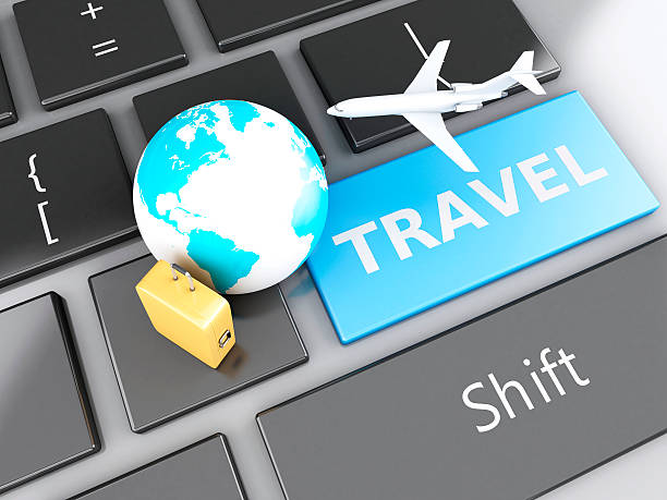 istock suitcase, airplane and earth on computer keyboard. Travel concept 530602519