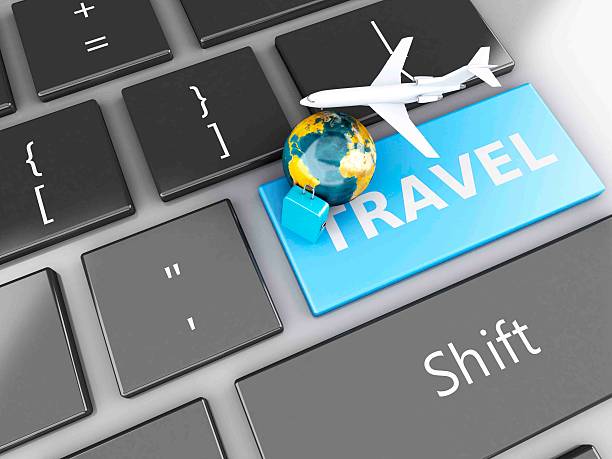 istock suitcase, airplane and earth on computer keyboard. Travel concept 530603389