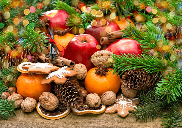 istock Fruits, cookies and spices. Christmas background with lights 530603985