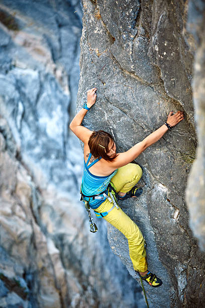 istock Rock climber climbing up a cliff 530604617