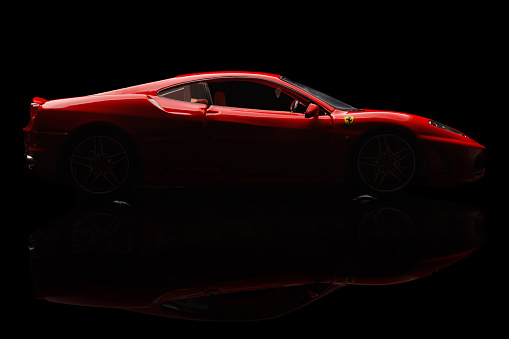 Krivoy Rog, Ukraine - December  25, 2014: Toy ferrari F430 on black backgrond. The photo is made in a studio. Editorial Use Only.