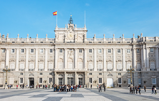 Madrid, Spain - November 22, 2014: Royal Palace facade with tourists visiting