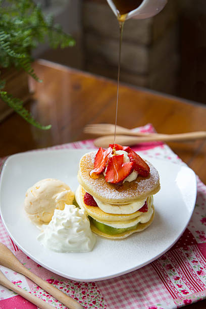 pancakes with strawberry, kiwi and whipped cream stock photo
