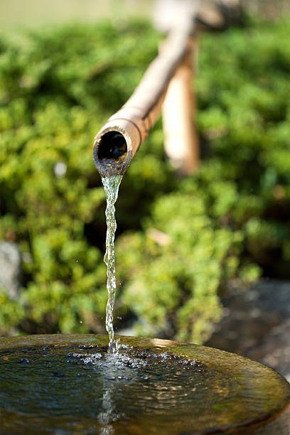 istock Bamboo tube and flowing water 530616597