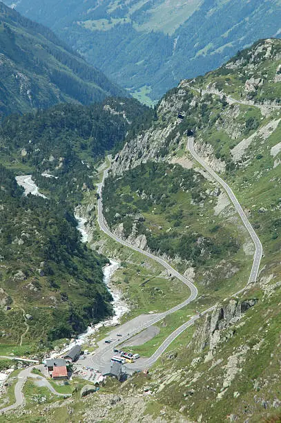 Road, buildings and valley nearby Sustenpass in Alps in Switzerland.