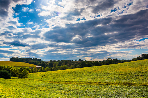 Evening sky over farm fields and rolling hills near Stewartstown, Pennsylvania.