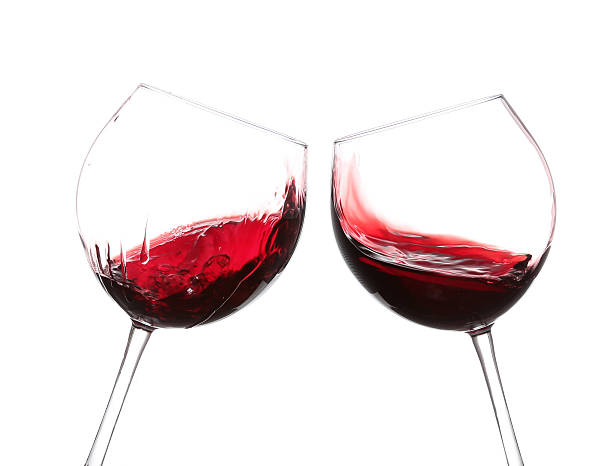 istock red wine swirling in a goblet wine glass, 530626443