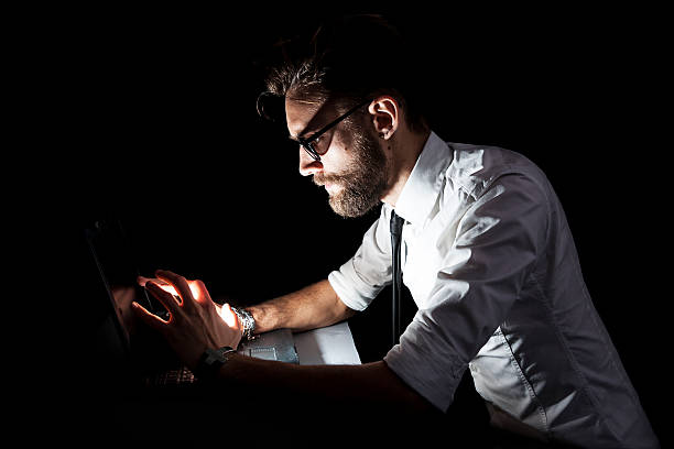 istock businessman at the computer that gives off light 530628643