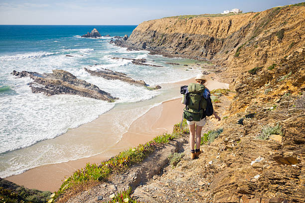 female hiker with rucksack hiker on hiking trail  along coast portugal , rota vicentina. HDR image algarve stock pictures, royalty-free photos & images