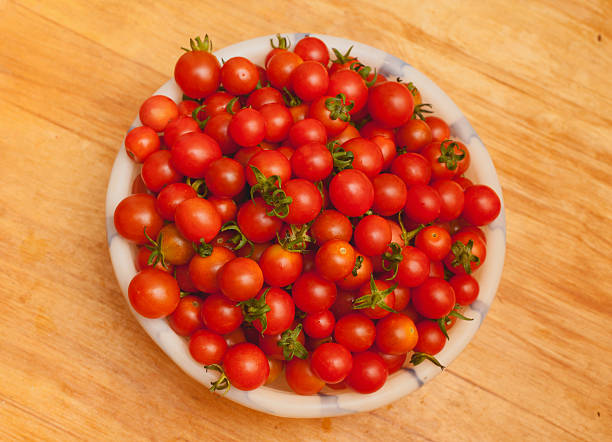 istock heap of many small red ripe cherry tomatoes 530629909