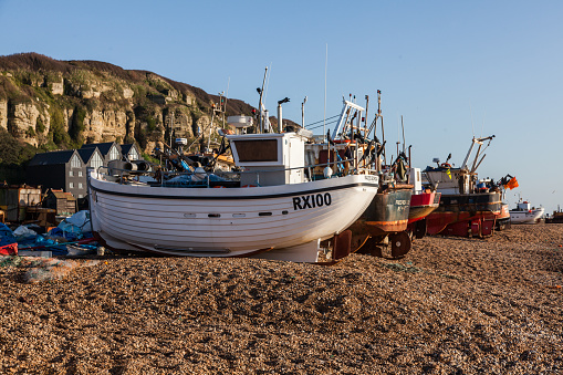 Hastings, England - December 25, 2014: Fishing Boat on the beach at Hastings, buildings can be seen in the background 