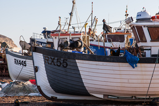 Hastings, England - December 25, 2014: Fishing Boat on the beach at Hastings, buildings can be seen in the background 