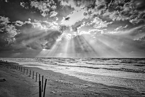 Seascape with sunbeams in black and white