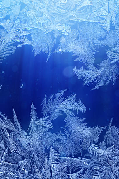 istock Winter night behind frozen window glass 530635203