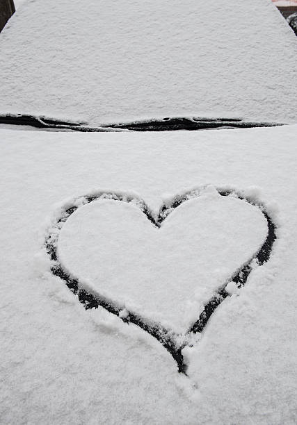 istock Heart shape of snow on the car 530637793