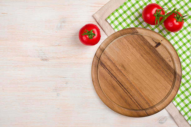 istock Top view of kitchen cutting board over wooden background 530640457