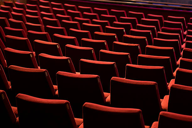 Empty Theater Chairs Empty theater with red chairs. Rear view. opera stock pictures, royalty-free photos & images