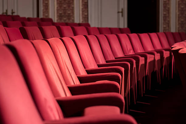 Empty Theater Chairs Empty theater with red chairs. Close up view. opera stock pictures, royalty-free photos & images