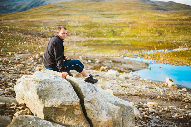 istock Man Sitting On Stone In Norwegian Mountains 530642061